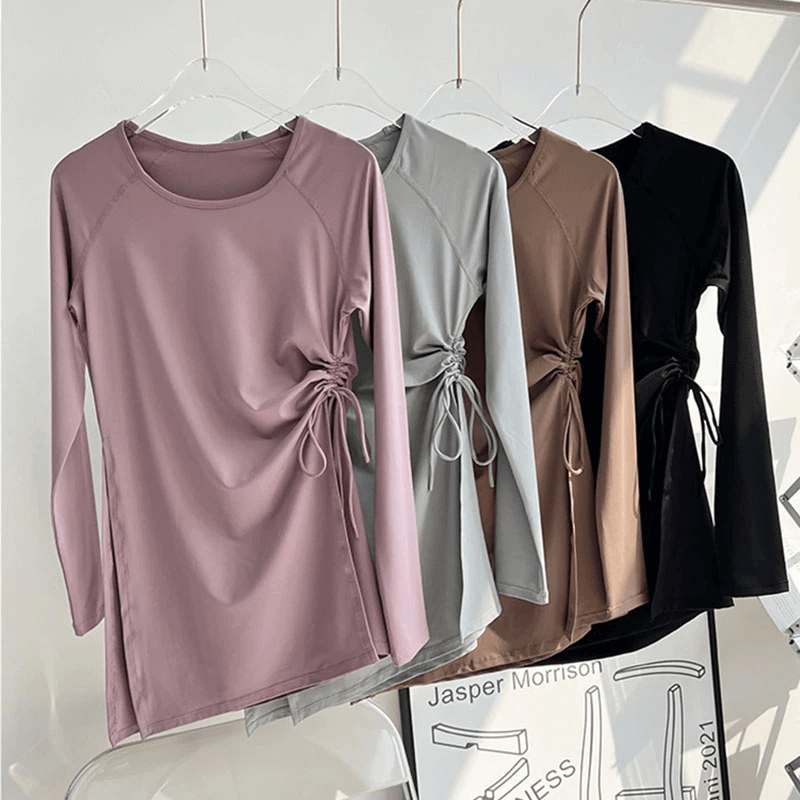 Collection of sports waist drawstring tops in pastel and neutral shades hanging on hangers, perfect for fitness and comfort.
